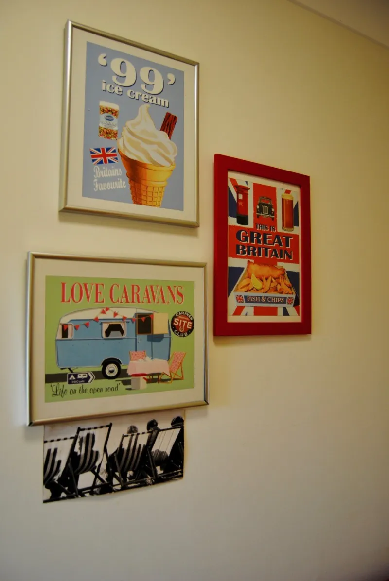 Retro posters on a corridor wall, including a 99 ice cream and a caravan